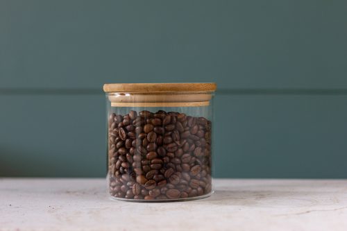 A transparent jar of coffee Arabica and Robusta coffee beans