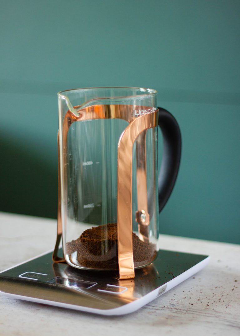 Adding coffee to a French Press