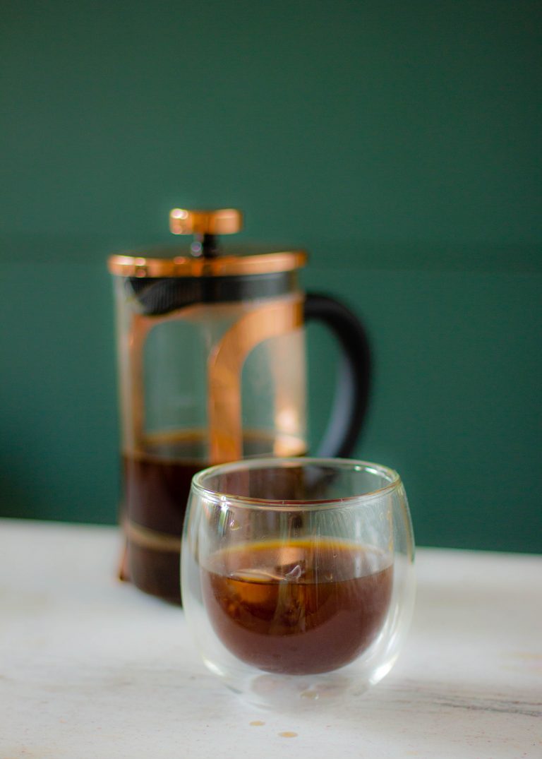 Pouring brewed coffee in a glass